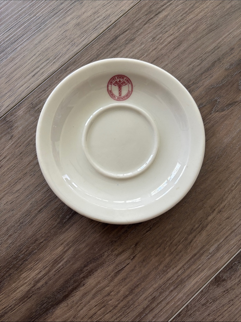 Cream Ceramic Saucer with Red Accent Logo